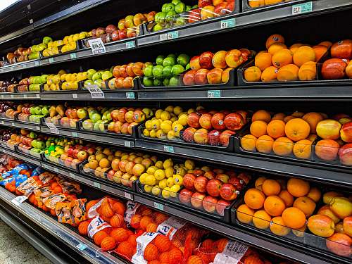 grocery store yellow and red apples on black plastic crate shop
